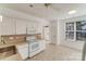 Open kitchen featuring white cabinets, mosaic backsplash, and stainless steel appliances at 563 Goldstaff Ln, Charlotte, NC 28273