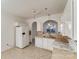 Well-lit kitchen with white appliances, tile backsplash, and stone-look flooring at 563 Goldstaff Ln, Charlotte, NC 28273