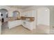 Bright kitchen with white cabinets, mosaic backsplash, and unique tile flooring at 563 Goldstaff Ln, Charlotte, NC 28273