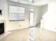Cozy living room with fireplace, window, and door leading to outdoors at 563 Goldstaff Ln, Charlotte, NC 28273