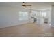 Open-concept living room with wood floors, a ceiling fan and a view into the kitchen with stainless appliances at 818 Fairview St # B, Kannapolis, NC 28083