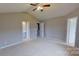 The bedroom includes neutral walls, a ceiling fan, and a door to an en suite bathroom at 8403 Spirea Ct, Charlotte, NC 28215
