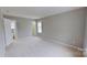 Bright, carpeted bedroom provides a calm atmosphere with natural light and neutral decor at 8403 Spirea Ct, Charlotte, NC 28215