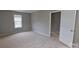 A serene bedroom with natural light, soft carpet, and neutral walls creating a relaxing atmosphere at 8403 Spirea Ct, Charlotte, NC 28215