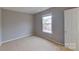 Cozy bedroom featuring natural light from the window and neutral paint for a serene feel at 8403 Spirea Ct, Charlotte, NC 28215