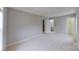 This bedroom features neutral walls and carpet, plus a door to an en suite bathroom at 8403 Spirea Ct, Charlotte, NC 28215
