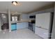 Kitchen featuring blue cabinets, stainless appliances, granite counters open to other living areas at 8403 Spirea Ct, Charlotte, NC 28215