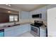 Kitchen featuring blue cabinets, granite countertops, and stainless steel appliances adding modern style at 8403 Spirea Ct, Charlotte, NC 28215