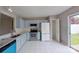 Bright kitchen showcases blue cabinets, granite countertops, stainless steel appliances, and tiled floors at 8403 Spirea Ct, Charlotte, NC 28215