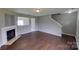 View of the living room with a fireplace and wood-look floors, creating a cozy ambiance at 8403 Spirea Ct, Charlotte, NC 28215