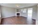 Open living room features wood-look floors, fireplace, and seamless connection to the kitchen at 8403 Spirea Ct, Charlotte, NC 28215