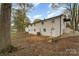 Backyard view of the two-story white brick home showcasing well-kept landscaping at 919 N Weldon St, Gastonia, NC 28052