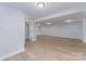 Finished basement showcasing open space and neutral walls with wood-look floors at 919 N Weldon St, Gastonia, NC 28052