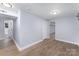 Finished basement with neutral walls, wood-look floors, and views of the basement bathroom at 919 N Weldon St, Gastonia, NC 28052