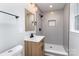Updated bathroom featuring hexagon tile shower with niche, modern vanity and fixtures at 919 N Weldon St, Gastonia, NC 28052