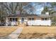 Charming white brick ranch with blue door, light wood accents, and a well-manicured front yard at 919 N Weldon St, Gastonia, NC 28052