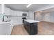 Bright kitchen features new stainless appliances, white cabinets and a central island at 919 N Weldon St, Gastonia, NC 28052