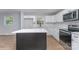 Bright kitchen features new stainless appliances, quartz counters and a central island at 919 N Weldon St, Gastonia, NC 28052