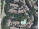Aerial view showing home location in a wooded neighborhood with pool at 10105 Reindeer Way Ln, Charlotte, NC 28216