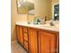 Double vanity bathroom with wood cabinets at 10105 Reindeer Way Ln, Charlotte, NC 28216