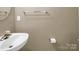 Small bathroom with pedestal sink and toilet at 10105 Reindeer Way Ln, Charlotte, NC 28216