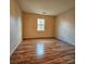 Simple bedroom with wood flooring and window at 10105 Reindeer Way Ln, Charlotte, NC 28216