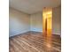 Bright bedroom with wood flooring and access to hallway at 10105 Reindeer Way Ln, Charlotte, NC 28216