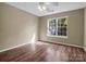 Simple bedroom with wood floors and a window at 10105 Reindeer Way Ln, Charlotte, NC 28216
