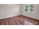 Well-lit bedroom, featuring wood floors and a large window at 10105 Reindeer Way Ln, Charlotte, NC 28216
