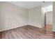 Simple bedroom with hardwood floors and door to hallway at 10105 Reindeer Way Ln, Charlotte, NC 28216