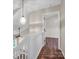 Upstairs hallway with white railing and pendant lighting at 10105 Reindeer Way Ln, Charlotte, NC 28216