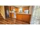 Galley kitchen features wood cabinets, laminate flooring and an island at 10105 Reindeer Way Ln, Charlotte, NC 28216
