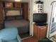 Comfortable bedroom featuring a queen bed, storage, and a TV at 127 Deer Park Rd # D16, Mount Gilead, NC 27306