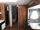 Cozy living room featuring wood-look flooring and ample storage cabinets at 127 Deer Park Rd # D16, Mount Gilead, NC 27306