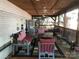 Relax on this covered porch, complete with comfortable seating and ceiling fans at 127 Deer Park Rd # D16, Mount Gilead, NC 27306
