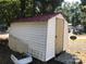 This backyard shed with red roof offers extra storage at 127 Deer Park Rd # D16, Mount Gilead, NC 27306