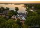 Breathtaking aerial view of lakefront home featuring lush greenery and private dock at 16921 Jetton Rd, Cornelius, NC 28031