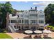 Spacious backyard with pool, lounge chairs, umbrellas and expansive patio perfect for entertaining at 16921 Jetton Rd, Cornelius, NC 28031