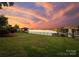 Waterfront backyard with a gazebo and boat dock featuring lush green lawn and a beautiful view at 16921 Jetton Rd, Cornelius, NC 28031