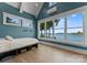 Bright bedroom with lake views features vaulted ceilings, large windows, and a built-in bed frame for storage at 16921 Jetton Rd, Cornelius, NC 28031