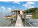 Picturesque waterfront dock featuring a covered boat slip and a serene view of the lake at 16921 Jetton Rd, Cornelius, NC 28031