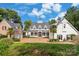 Stunning two-story home with manicured lawn, brick driveway, and charming architectural details at 16921 Jetton Rd, Cornelius, NC 28031