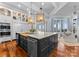 Open kitchen with a large island, stainless appliances, and views of the water at 16921 Jetton Rd, Cornelius, NC 28031