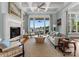 Bright living room features a fireplace, coffered ceilings and scenic lake views at 16921 Jetton Rd, Cornelius, NC 28031