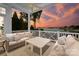 Covered patio with comfortable seating overlooking the lake provides an ideal outdoor living space at 16921 Jetton Rd, Cornelius, NC 28031