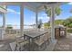Outdoor dining area on porch features a stone floor, a grill and lake views at 16921 Jetton Rd, Cornelius, NC 28031