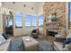 Bright sunroom featuring large windows, brick fireplace, and comfortable seating with water views at 16921 Jetton Rd, Cornelius, NC 28031