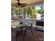 Screened porch with lake view, table and chairs, and ceiling fan at 190 Nicks Rd, Norwood, NC 28128