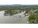 Aerial view of a lake community with numerous boats docked at a marina and lush forests in the background at 287 Ben Eller Ln, Taylorsville, NC 28681