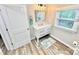 Updated bathroom featuring white vanity, modern fixtures, and a bright window for natural light at 287 Ben Eller Ln, Taylorsville, NC 28681